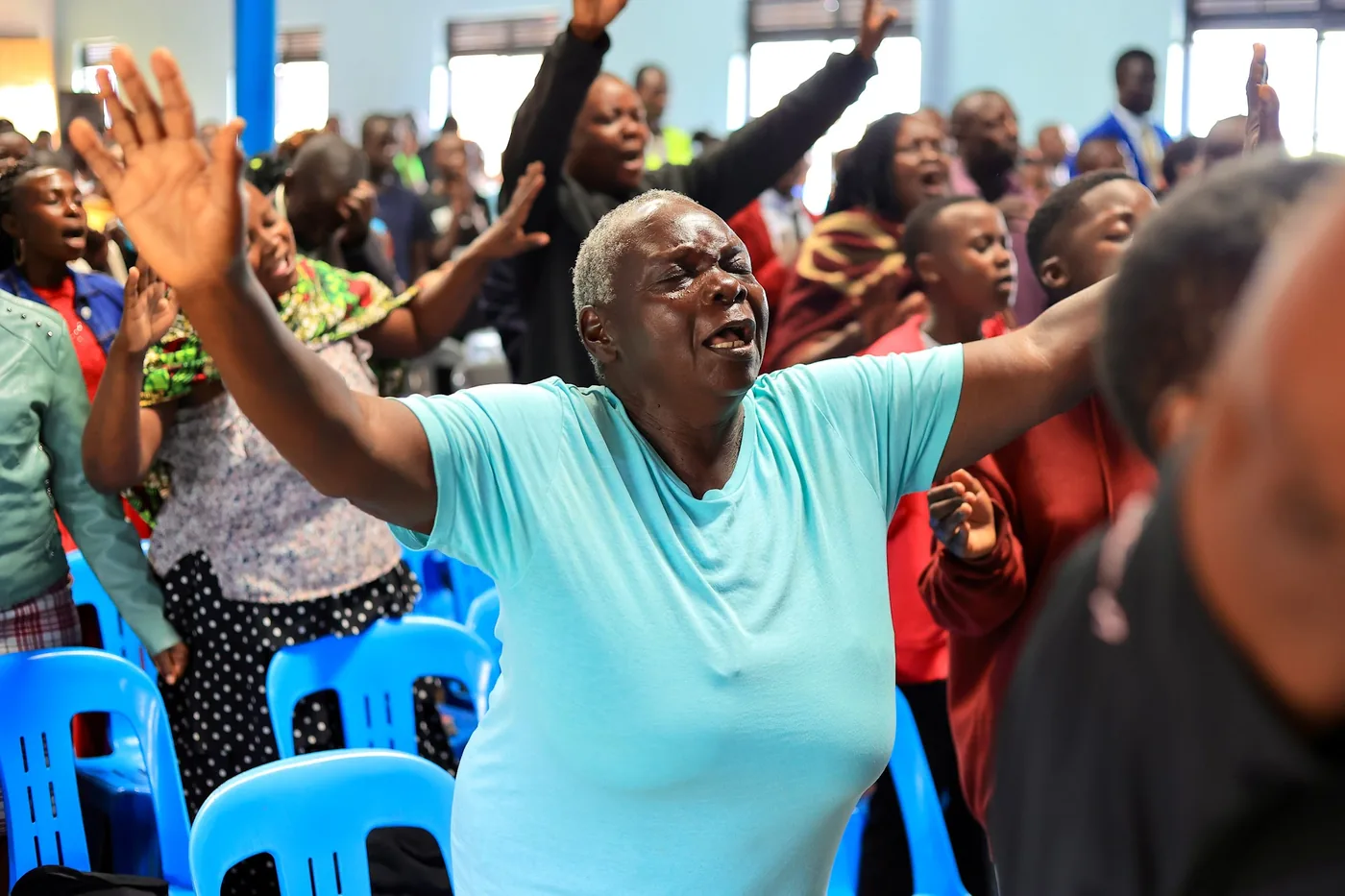A woman worshipping with both hands raised