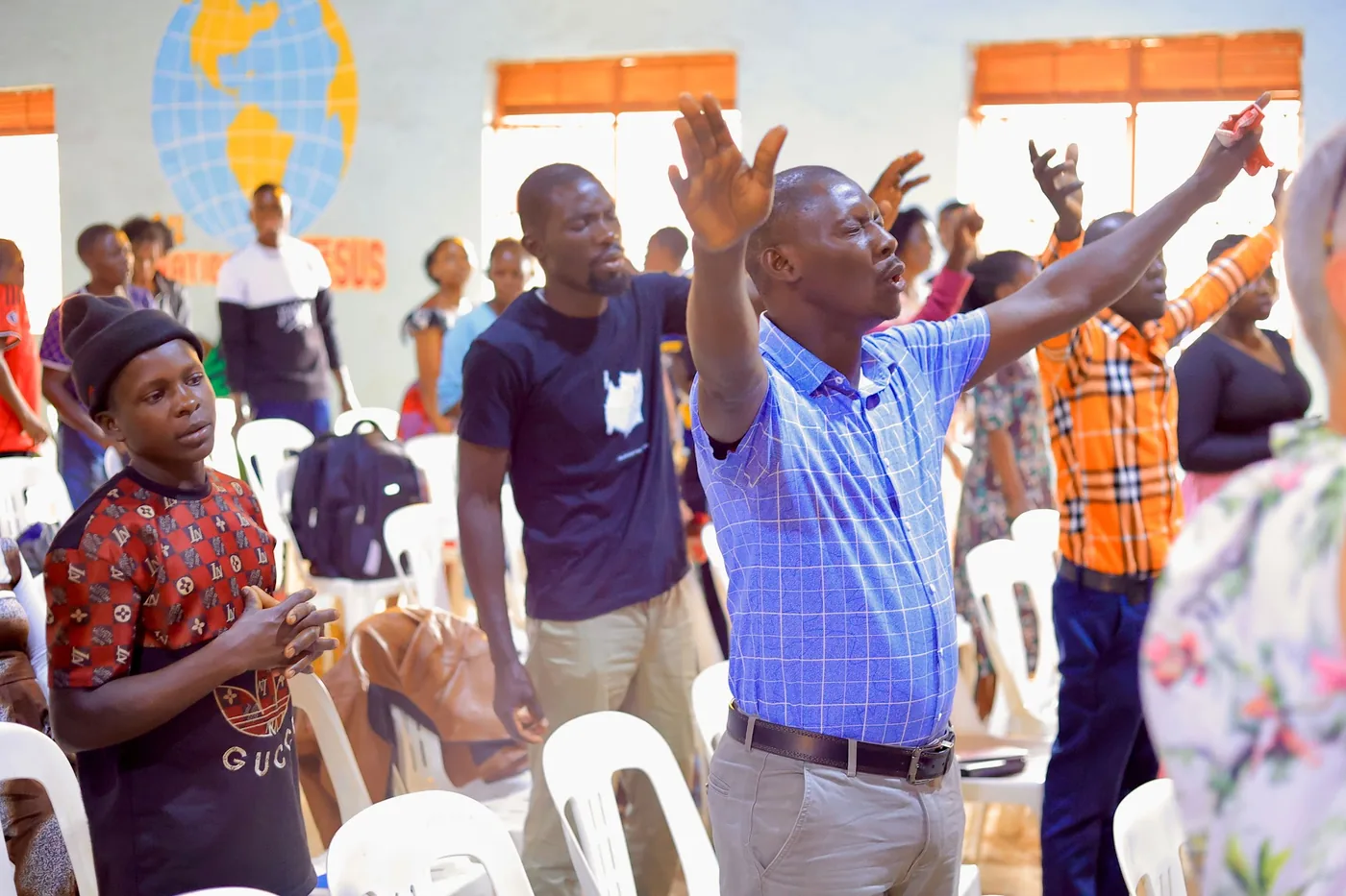 The congregation worshipping together with hands raised