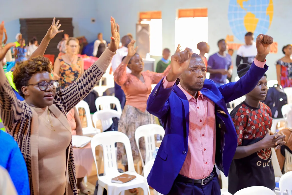 The congregation worshipping with hands raised