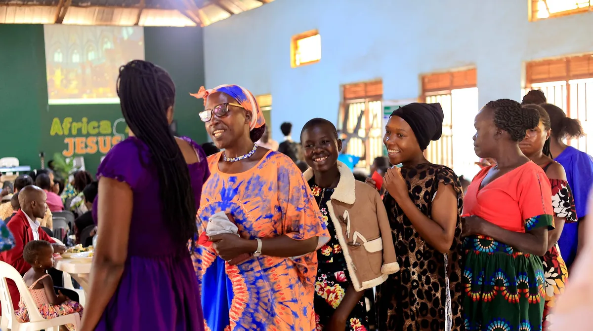 Members queuing with plates after a gathering