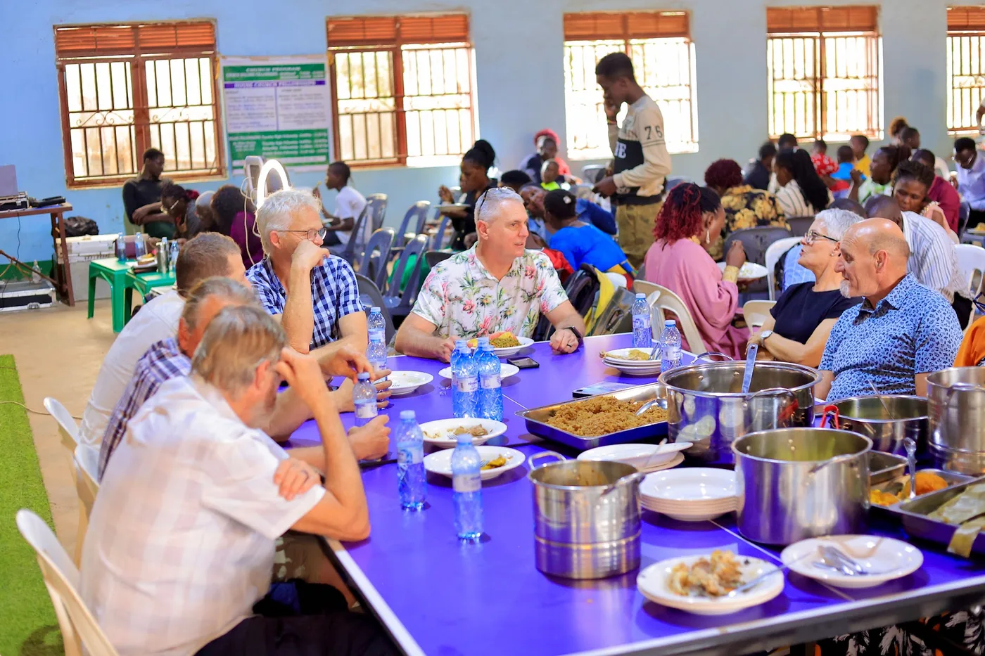 Long tables set for a shared meal after the gathering