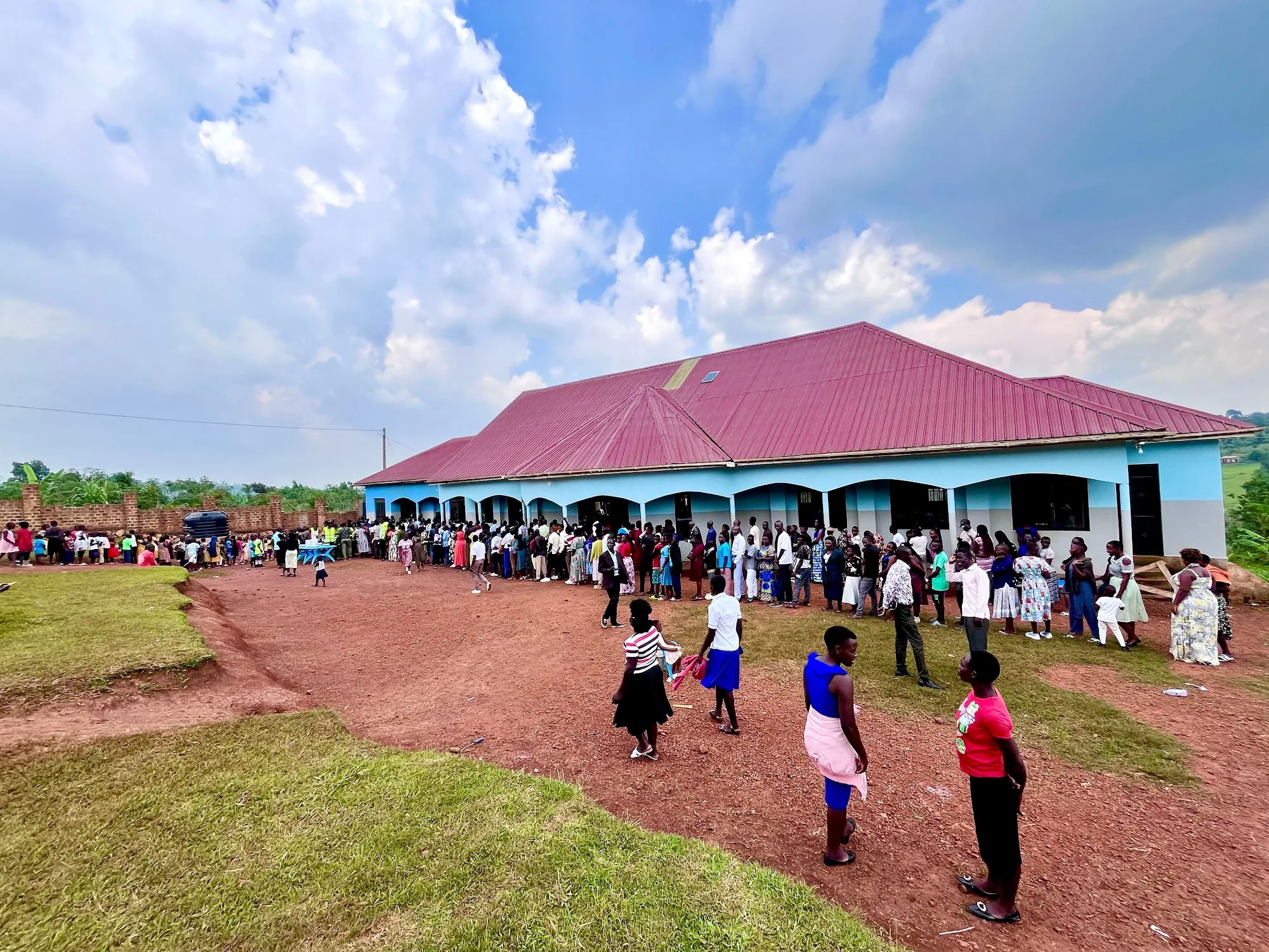 The ministry compound with people gathered outside under an open sky