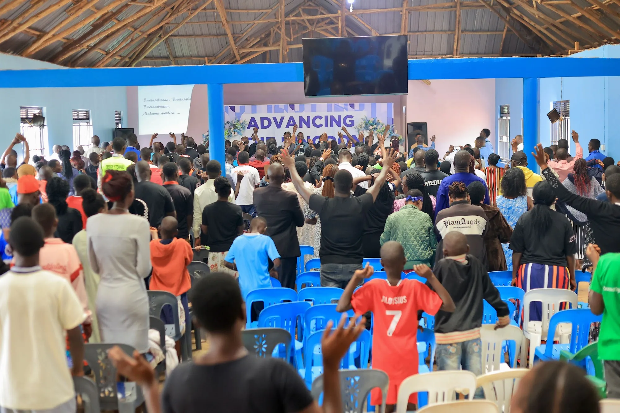 The congregation standing together in worship