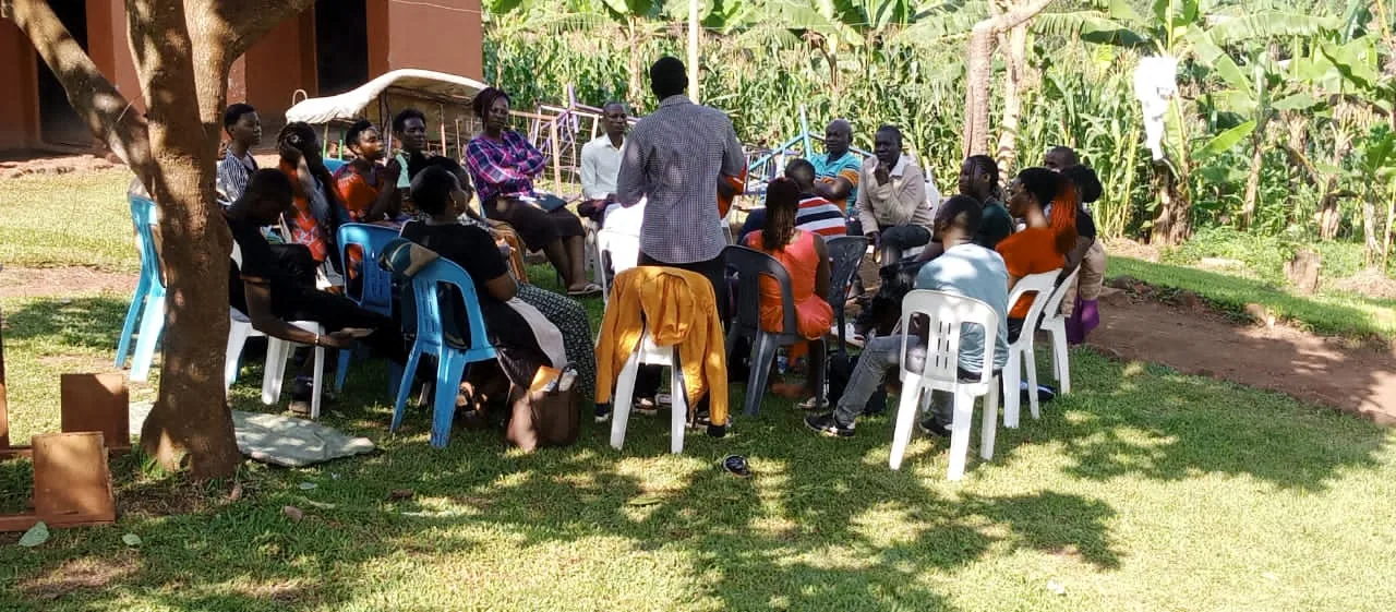 A gathering held outdoors under the trees