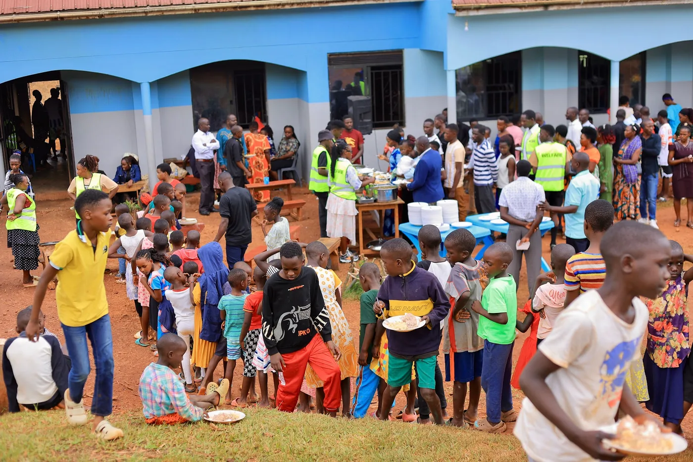 Children being served a meal on the school grounds