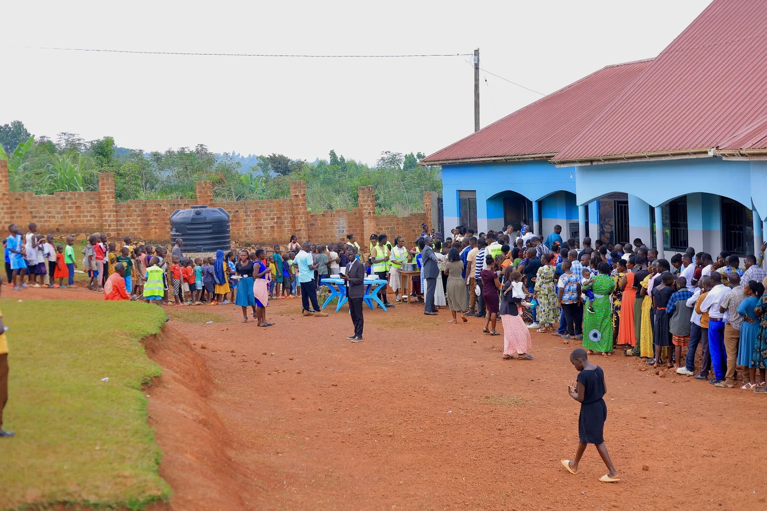 Children walking on the path outside the school buildings
