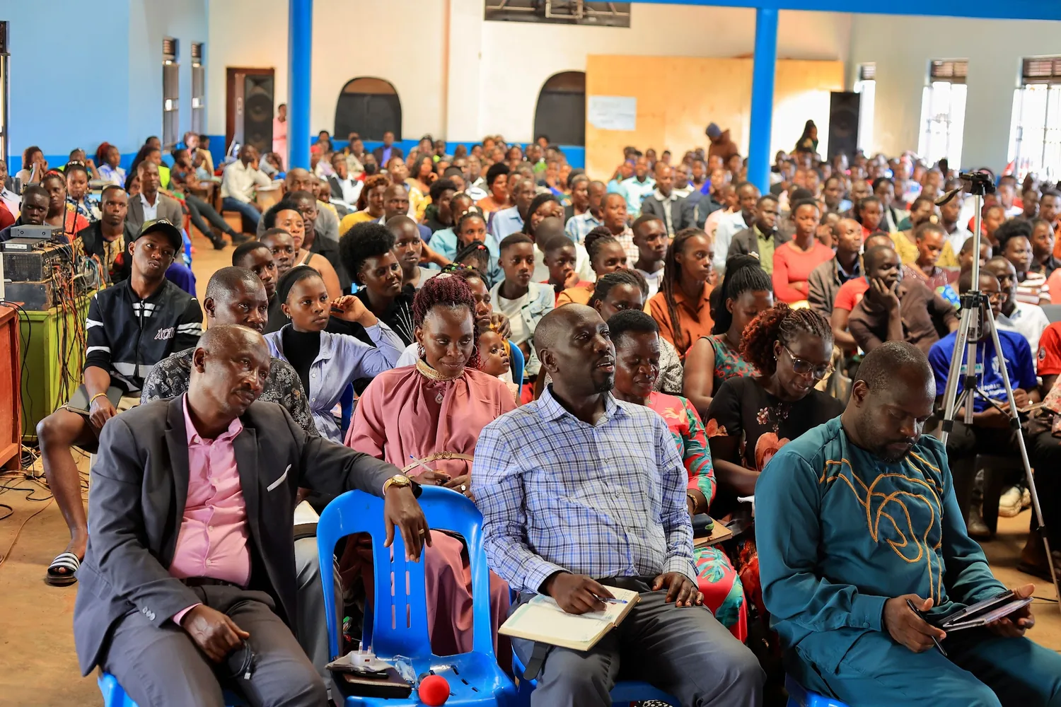 The congregation seated with notebooks and Bibles open