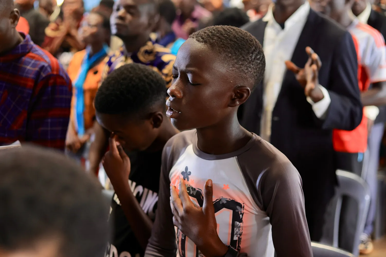 Two boys standing together during a gathering